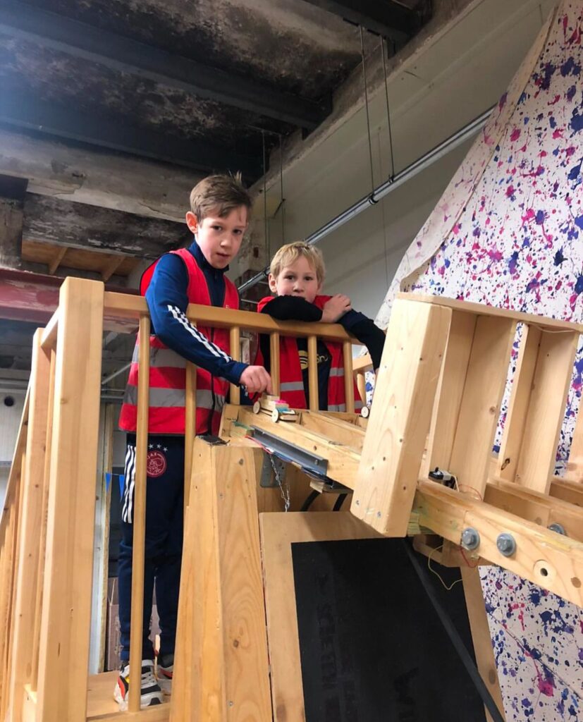 kinderen testen hun zelfgemaakte auto bij Sport-BSO Flekss